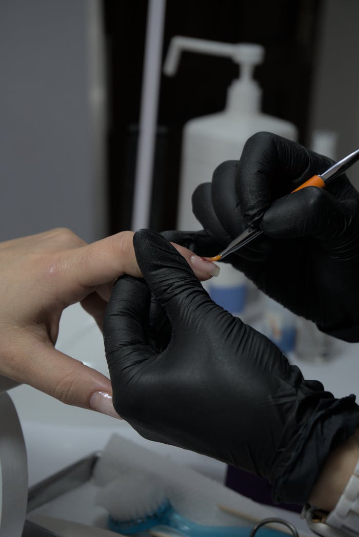 Close-up of a manicure, showcasing skilled nail art application in a salon.